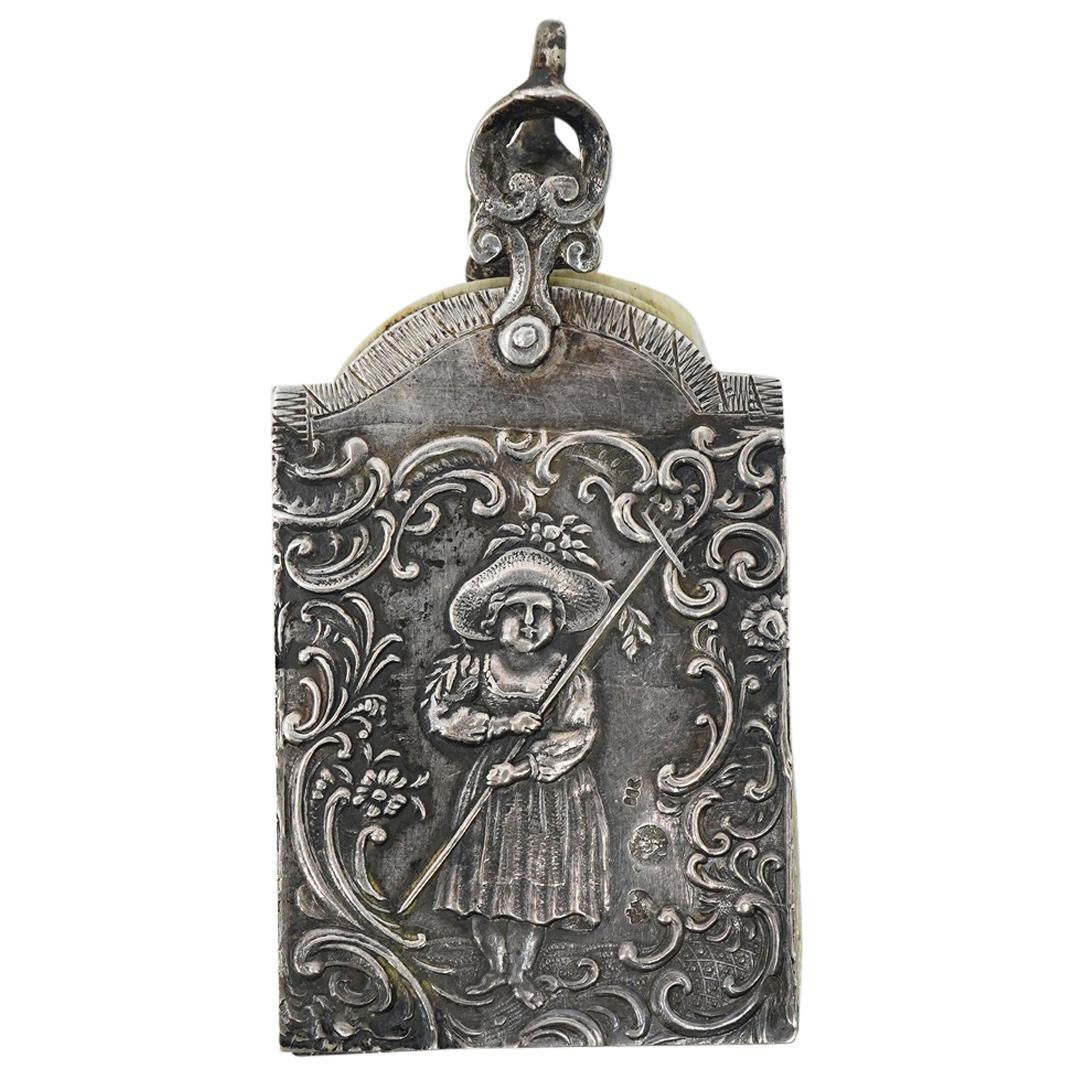 Antique 800 Silver & Bone Chatelaine Charm Note Book: DESCRIPTION: An antique 800 silver and bone chatelaine charm notebook, featuring three bone insert panels encased between two sterling silver plates. Both 800 silver covers are reticulated and decorat