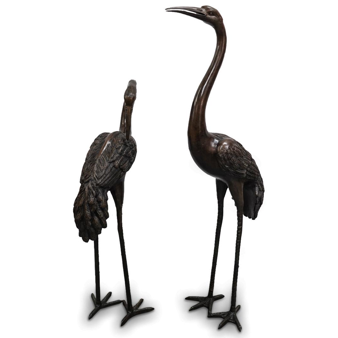 Pair of Meiji Japanese Bronze Crane Sculptures: DESCRIPTION: Pair of Meiji Japanese bronze sculptures depicting two standing cranes in varying poses with long curving necks, completed with details of feathers, deep eyes, and long arched beaks. CIRC