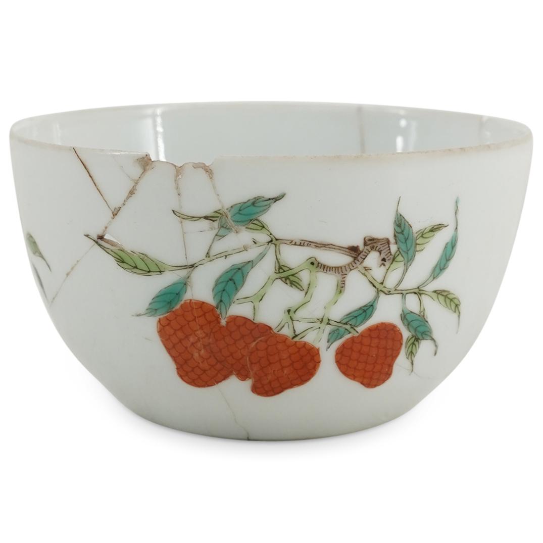 Chinese Miniature Porcelain Bowl: DESCRIPTION: Porcelain miniature bowl or teacup decorated with strawberry, flower, and foliage motifs against a white background. Marked on underside with Han characters claiming Yongzheng origin. CIR