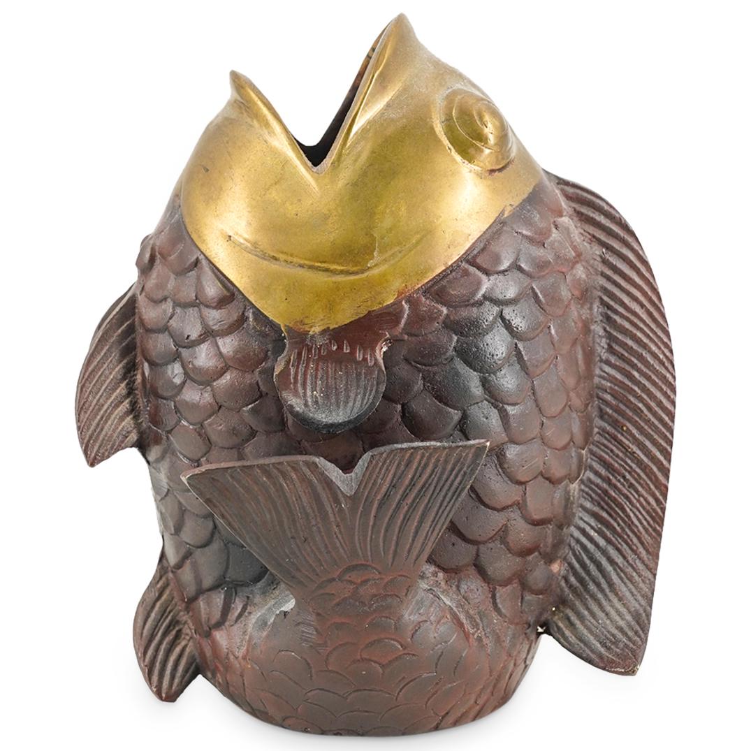 Vintage Japanese Bronze Fish Form Vase: DESCRIPTION: Bronze vase fashioned as a fish with a flexed tail and an open mouth. Piece is decorated with a gilt head and a patinated body. CIRCA: 20th Century ORIGIN: Japan DIMENSIONS: H: 6.5" W: 4.