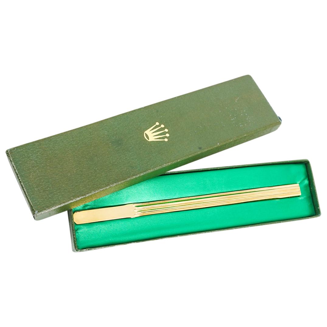 Vintage Rolex Gold Plated Letter Opener: DESCRIPTION: Vintage Rolex gold plated letter opener composed of a rectangular fluted handle transitioning to a faceted blade. Impressed at the side of the handle "Rolex". Sits in a green cardboard bo