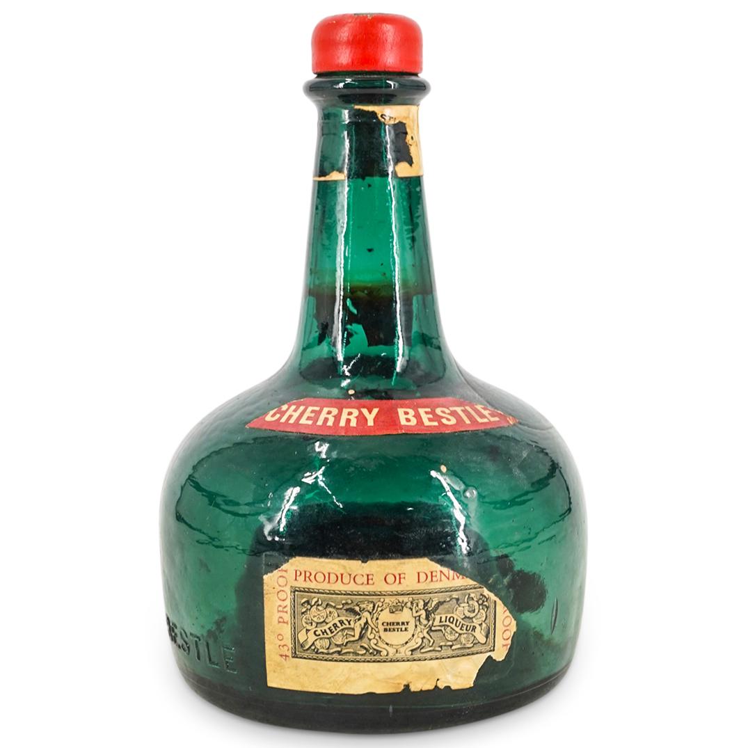 Danish Georg Bestle Liqueur Bottle "Jingle Bells" Music Box: DESCRIPTION: Glass bottle of Georg Bestle cherry liqueur converted into a music box which plays "Jingle Bells". Tested and fully functional. CIRCA: 20th Century ORIGIN: Denmark DIMENSIONS: H: 7.5" D: 