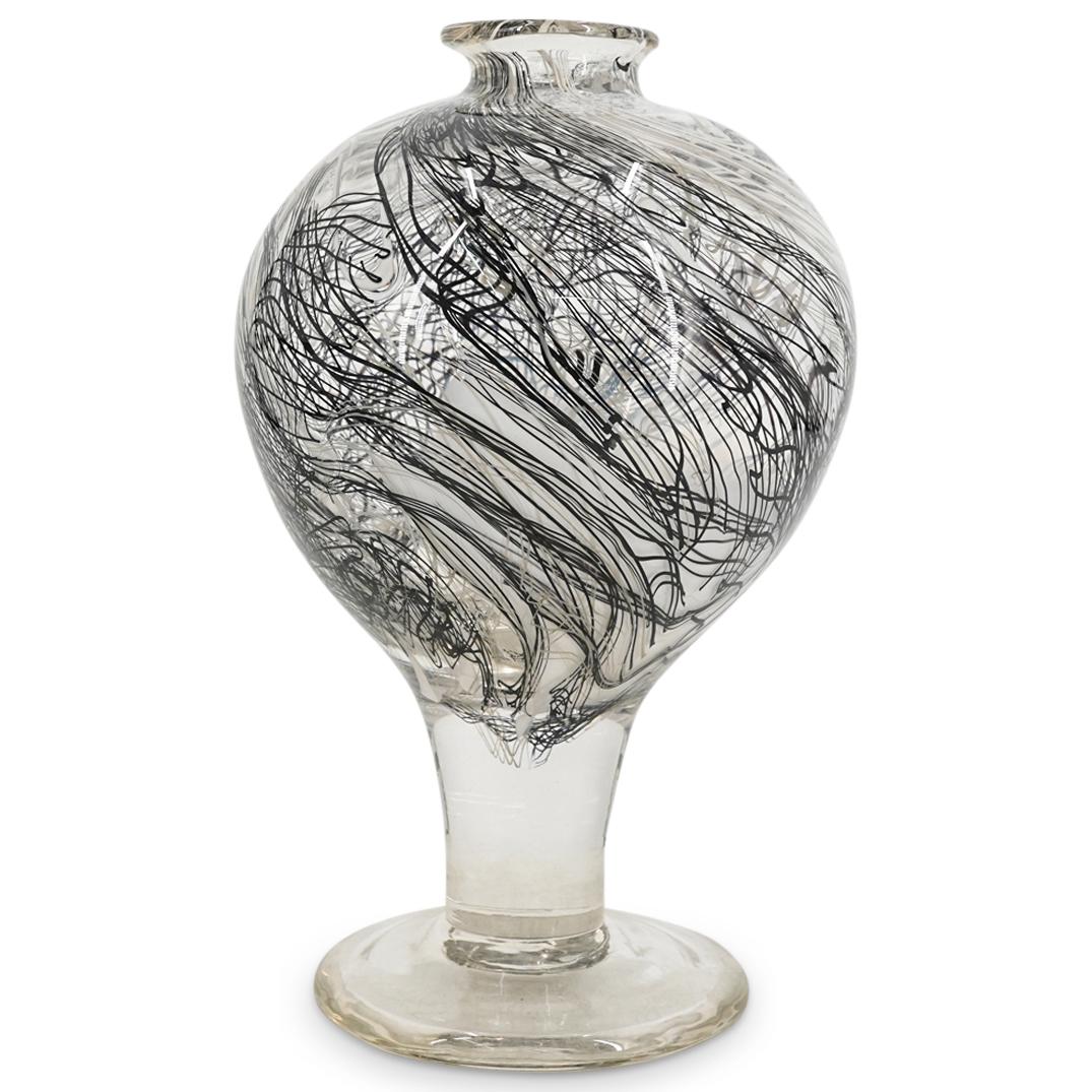Mid Century Black & White Murano Glass Vase: DESCRIPTION: Mid Century Murano glass vase featuring a transparent bulbous body imbued with black and white helical ribbons throughout, atop a tapering stem and round foot. CIRCA: Mid 20th Century ORI