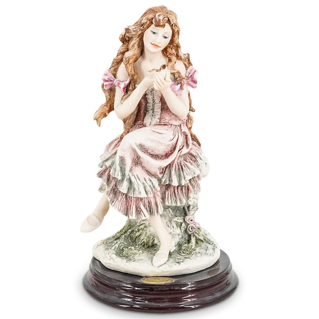 G. Armani "Fledgling" Capodimonte Porcelain Figurine: DESCRIPTION: A Giuseppe Armani Capodimonte Florence porcelain figurine. Model "Fledgling". Depicts a seated young girl holding a bird on her hands. With wooden base. Marked with the Capodimonte, Flore