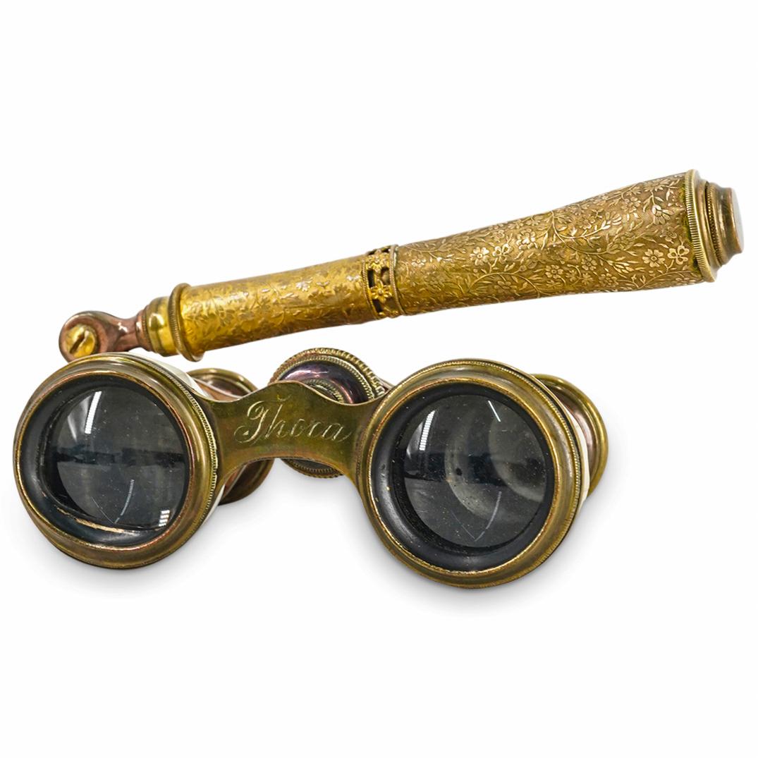 Antique French Mother Of Pearl And Brass Opera Glasses: DESCRIPTION: Exquisitely fashioned opera glasses featuring a gilt brass frame adorned around the lens casings with mother-of-pearl and embellished on the extendable handle with delicately etched flowe
