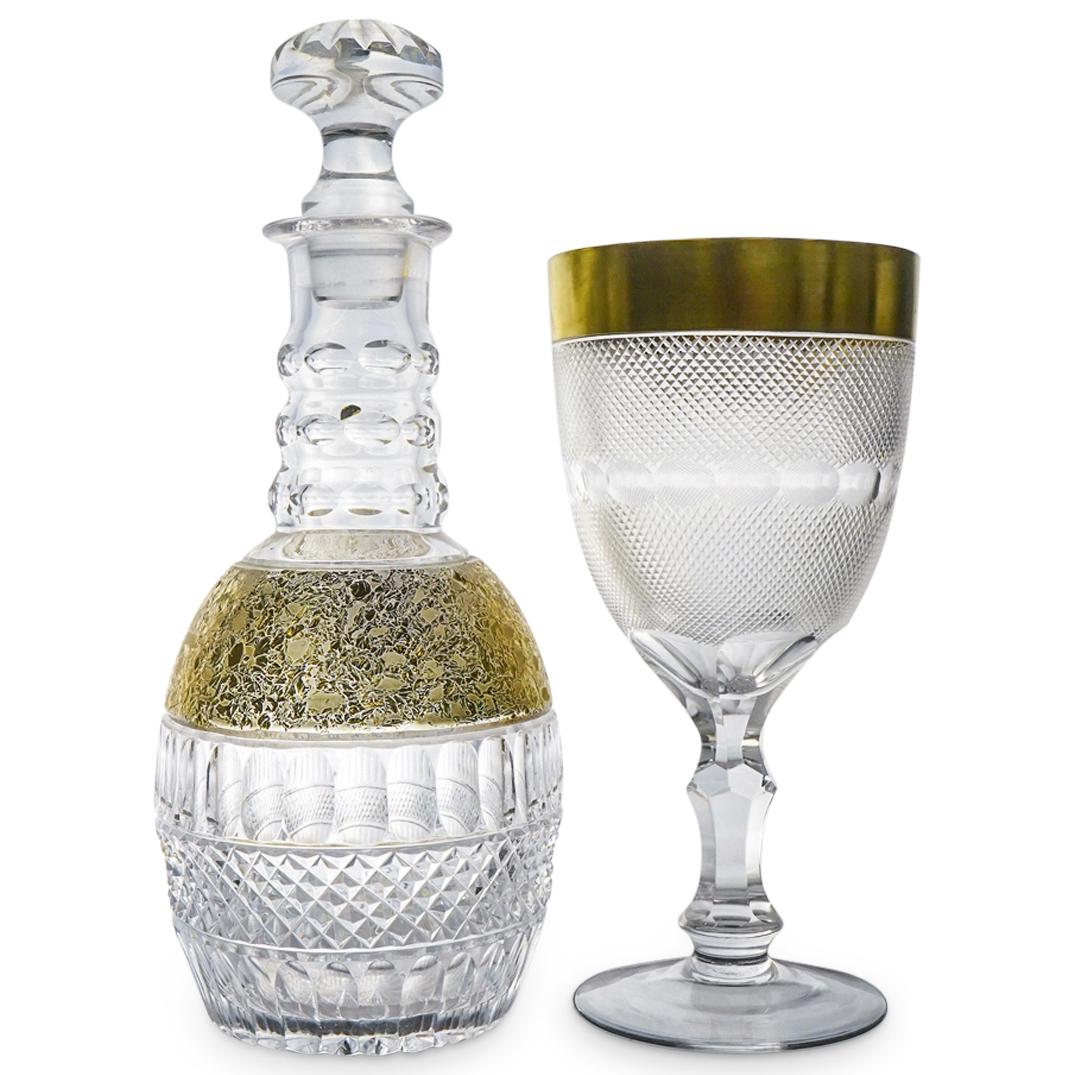 (2 Pc) Cut Crystal & Gold Decanter / Wine Goblet Set: DESCRIPTION: A crystal decanter and wine goblet two (2) piece grouping set, including: one (1) crystal decanter with stopper decorated with assorted cut crystal patterns, and encrusted gold accents; a