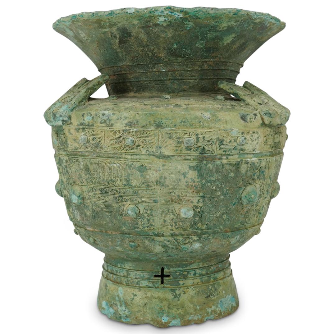 12th C. BC Shang Dynasty Bronze Zun: DESCRIPTION: Ancient Shang dynasty zun (ritual wine vessel) densely decorated with three pairs of taotie masks, three applied masks resembling bats, monoculi in two different sizes, and leiwen ("Chine