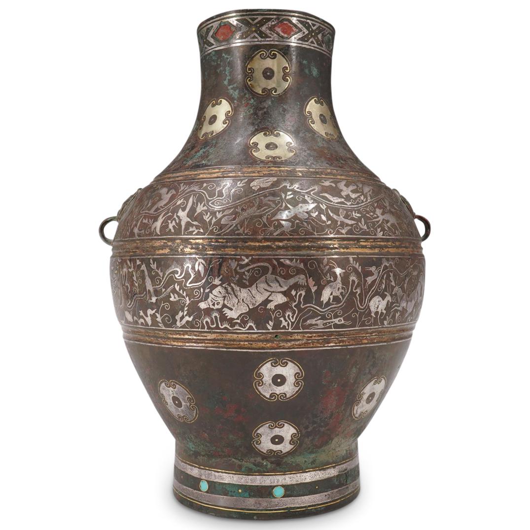 Warring States Period Gold, Silver, Turquoise Inlaid Bronze Bian Hu: DESCRIPTION: Ancient Warring States Period bronze hu (wine vessel) decorated around its center with two bands depicting in silver inlay various birds and monkeys on the upper and terrestrial creatures