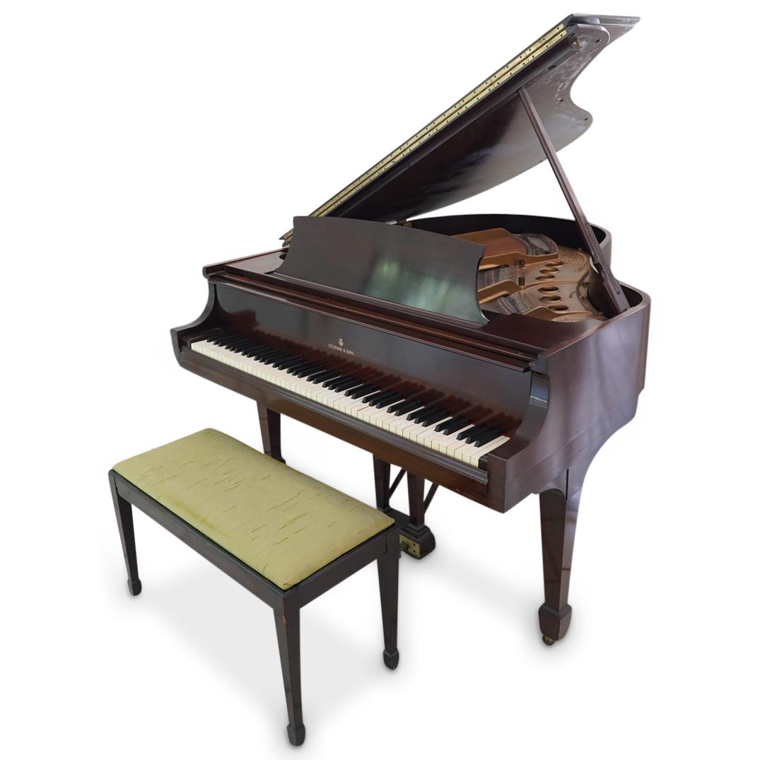 Steinway & Sons Series M (306482) Baby Grand Piano: DESCRIPTION: Steinway & Sons M series baby grand piano, serial number (306482) with brown wood foundation. Serial at plate between tuning keys: (M 306482) Marked: "Steinway & Sons New York" CIRCA: 20t