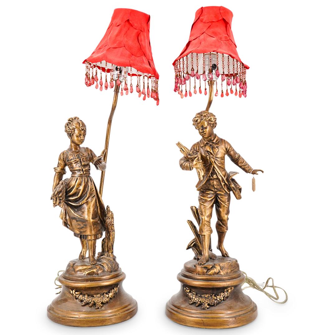 Pair of After Emile Bruchon "The Studious Pair" Metal Sculpture Lamps: DESCRIPTION: Pair of table lamps featuring patinated metal sculptures after Emile Bruchon work titled "The Studious Pair". Depicting a girl walking with a book, and a boy with a satchel and birds in a
