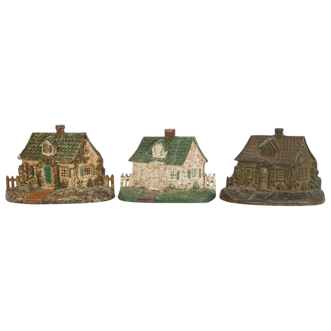 (3Pc) Antique Cast Iron Painted Cottage Doorstops: DESCRIPTION: (3Pc) Antique cast iron doorstops each colorfully painted and depicting cottages with details of windows, chimneys and flowers around the borders. Ref: 3913075188 A CIRCA: Early 20th Cent