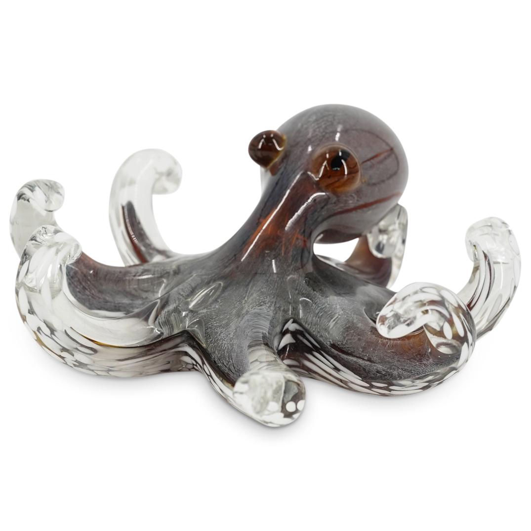 Murano Hand Blown Art Glass Octopus Figurine: DESCRIPTION: Murano hand blown art glass octopus figurine in clear glass with amber and white colored glass accents. CIRCA: 20th Century ORIGIN: Italy DIMENSIONS: H: 3 1/2" W: 9" Have a similar item t