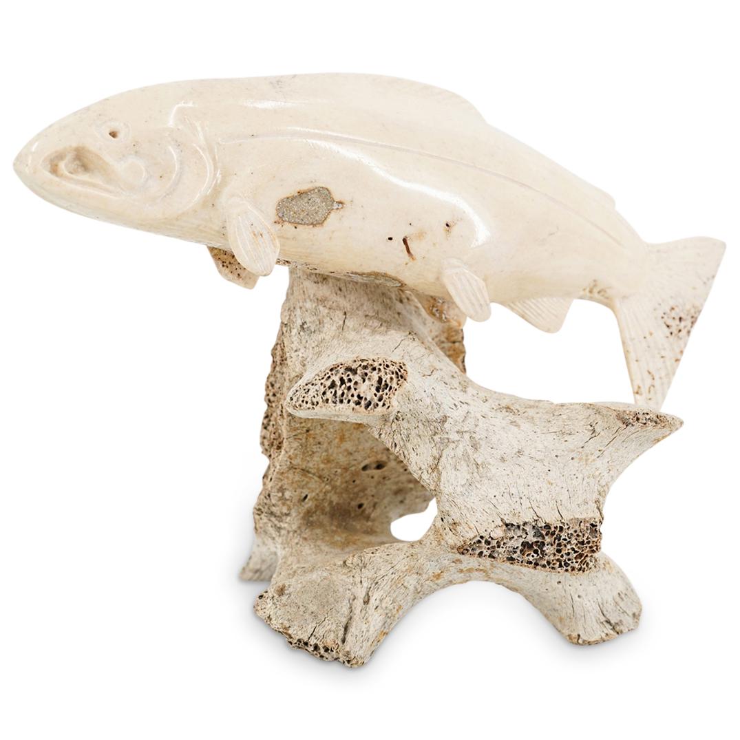 Signed R.E. Caved Whale, Walrus Bone Salmon: DESCRIPTION: Finely carved sculpture depicting a walrus bone salmon mounted atop a whale bone base. Initialed "R.E." at Salmon's tail. CIRCA: 20th Century ORIGIN: Pacific Northwest DIMENSIONS: H: 5.75