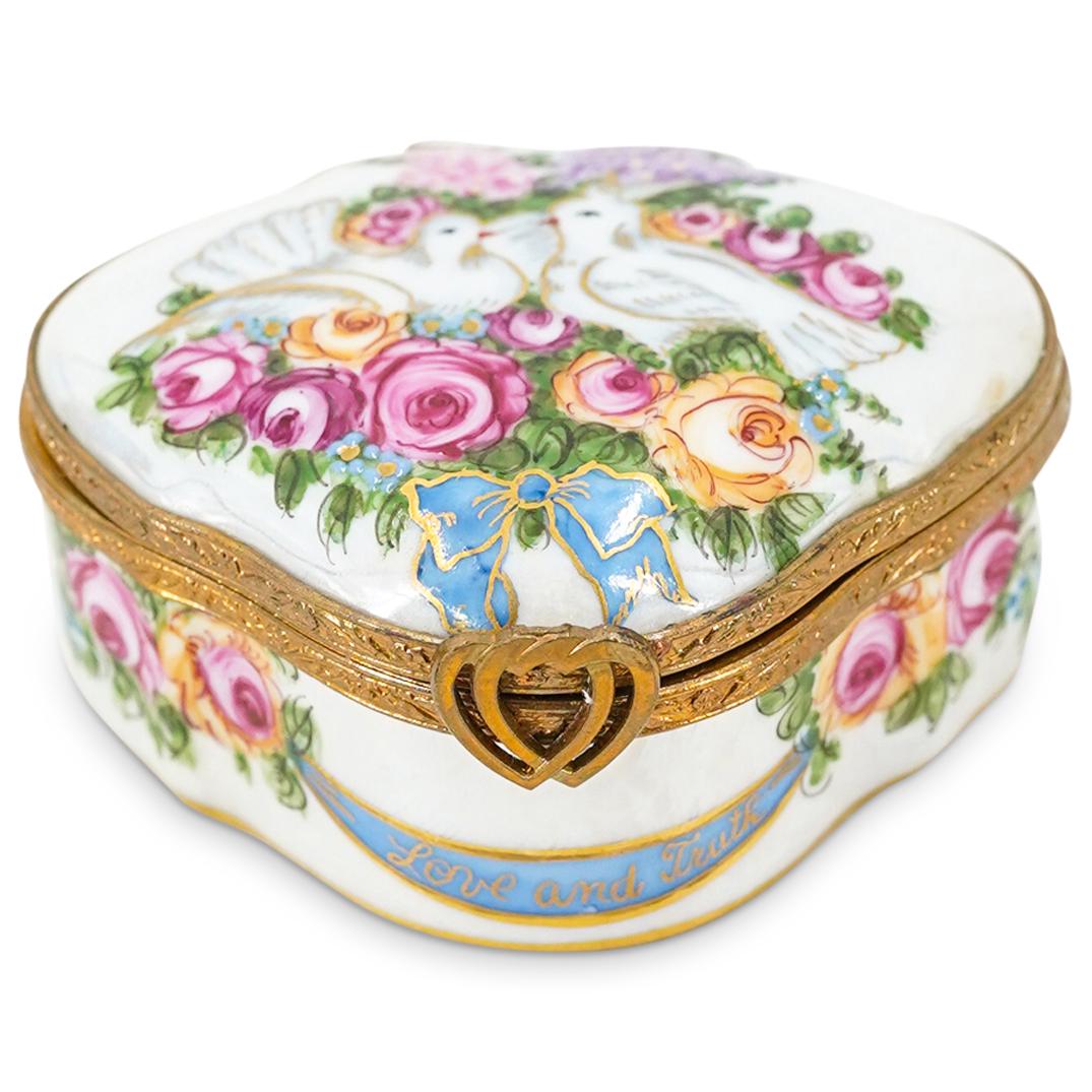 Limoges Porcelain "Love Doves" Trinket Box: DESCRIPTION: A Limoges porcelain "Love Doves" trinket box depicting floral painted decorations and a central motif with a pair of painted love doves. Marked on the underside: "Peint Main Limoges Franc