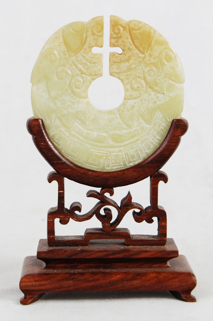 Chinese Antique Jade Serpentine Dragon Plaque: DESCRIPTION: Jade carved serpentine dragon disk plaque with Hard wood stand CIRCA: Early 1900's MADE IN: China DIMENSIONS: H: 5'' L: 3'' RESERVE: None