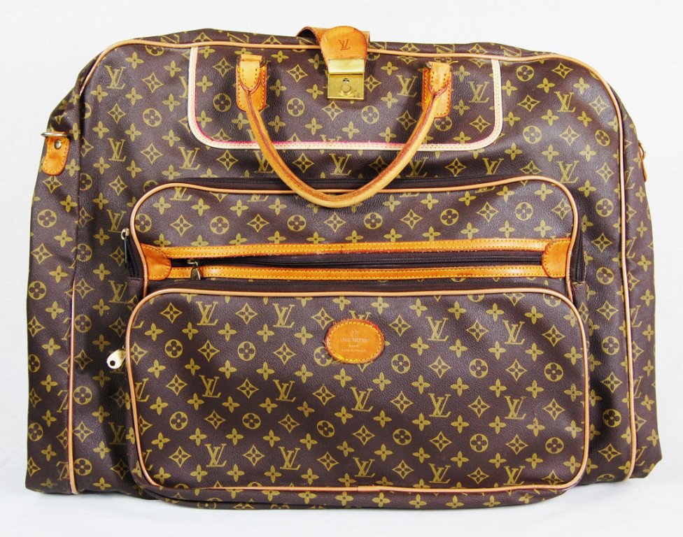 Louis Vuitton vintage garment suit case bag: DESCRIPTION: Louis Vuitton garment suit case bag CIRCA: 1960s MADE IN: France DIMENSIONS: H:20" L:25" RESERVE: None