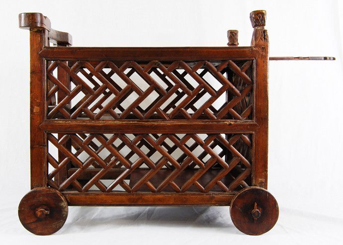Chinese antique hand made wood baby carriage: DESCRIPTION: Antique hand made wood baby carriage CIRCA: 1920s MADE IN: China DIMENSIONS: H:20.5" L:22.5" RESERVE: None