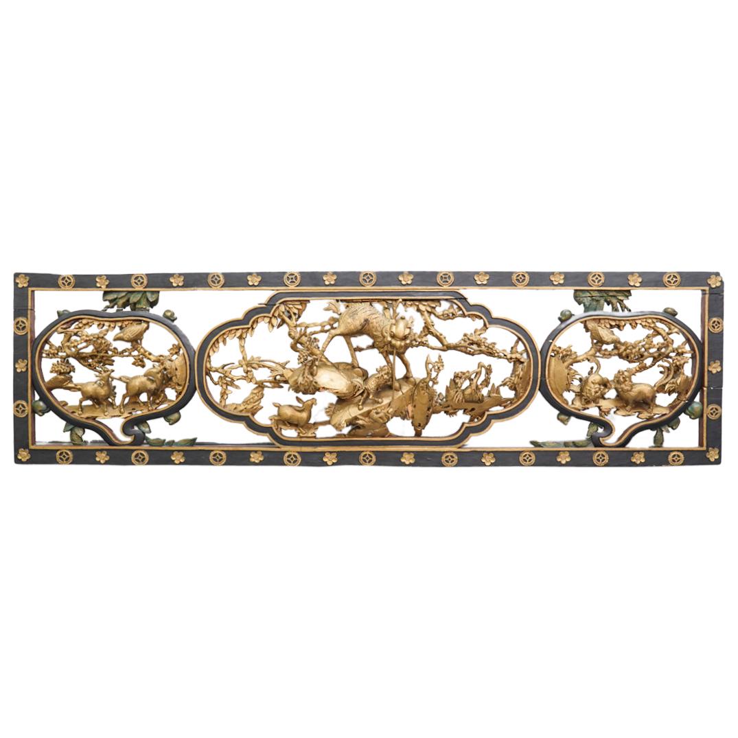 Antique Chinese Gilt Wood Carved Panel: DESCRIPTION: A large antique Chinese gilt and ebonized wood foundation with animalistic foo dog, bird, and rabbit forms, further designed with foliate CIRCA: 20th Century ORIGIN: China DIMENSIONS: H: 