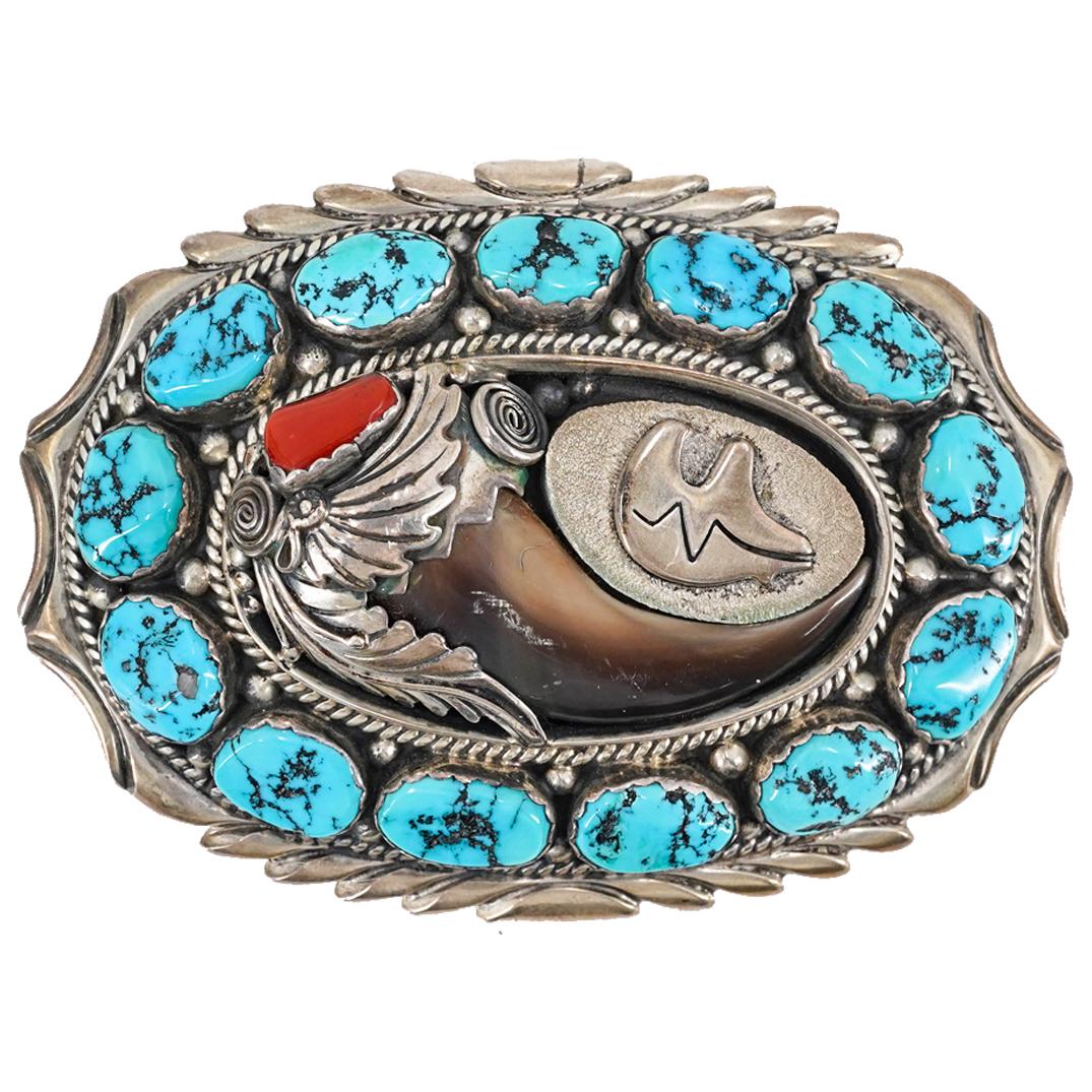 Danny Dale Sterling Silver, Turquoise, And Coral Belt Buckle: DESCRIPTION: Sterling silver belt buckle by Danny Dale featuring turquoise insets in a ring around a central insert of a bear's claw accented with coral and a sterling silver bear motif. Marked on ver