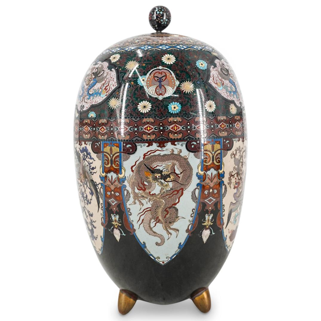 Antique Japanese Cloisonne Egg Dragon And Phoenix Vase: DESCRIPTION: Antique tripod cloisonne vase featuring an overall egg form crowned with a circular flower laden lid. Body bears exquisitely detailed, polychrome ryuu (dragon) and hou-ou (phoenix) crests