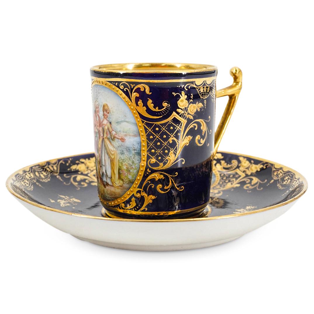 Antique Lamm Dresden Meissen Porcelain Demitasse And Saucer: DESCRIPTION: Meissen Lamm Dresden porcelain demitasse and matching saucer, each decorated with gilt flowers and foliage against a dark blue background. Demitasse is embellished with a scene of courtin