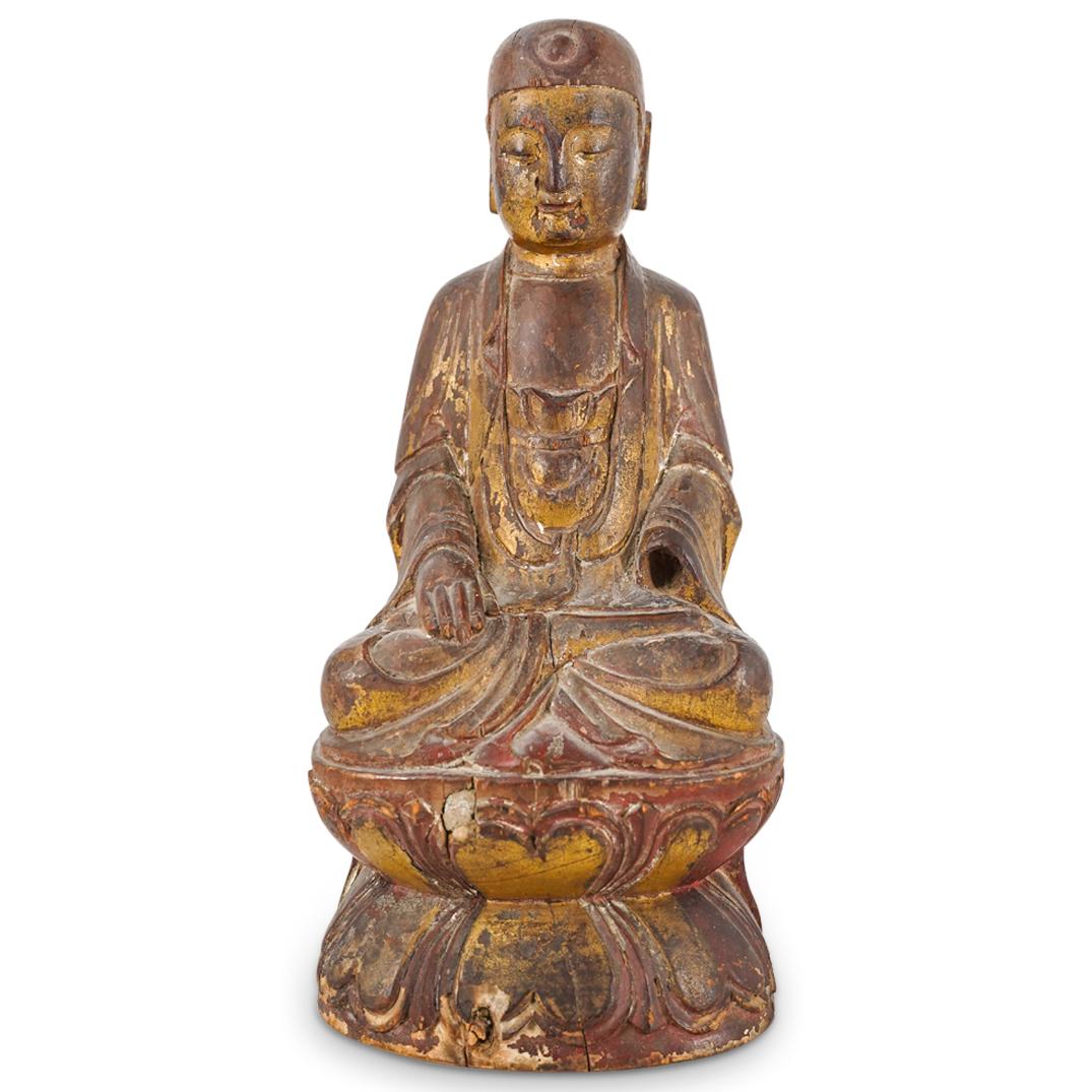 Antique Tibetan Wood Gilt Lacquer Buddha: DESCRIPTION: An Antique Tibetan buddha Siddhartha Gautama in robe garb seated atop a lotus base, completed with a red lacquered finish with remnants of gilt paint. CIRCA: 19th Cent. possibly older ORI