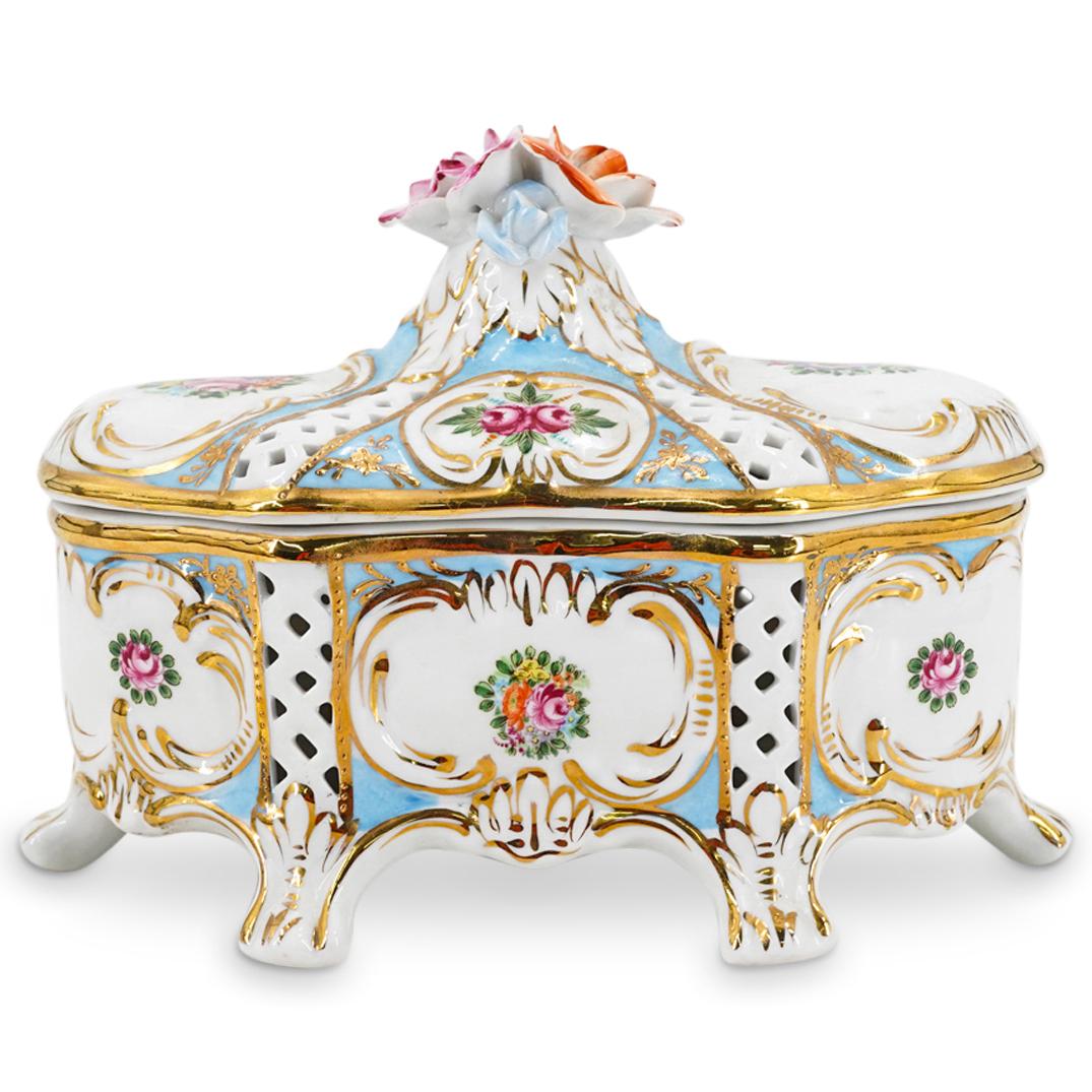 Antique KPM Porcelain Potpourri Box: DESCRIPTION: Antique porcelain potpourri box by the KÃ¶nigliche Porzellan-Manufaktur (KPM) featuring an oblong design on six feet and decorated on the reticulated sides with floral and foliage motif