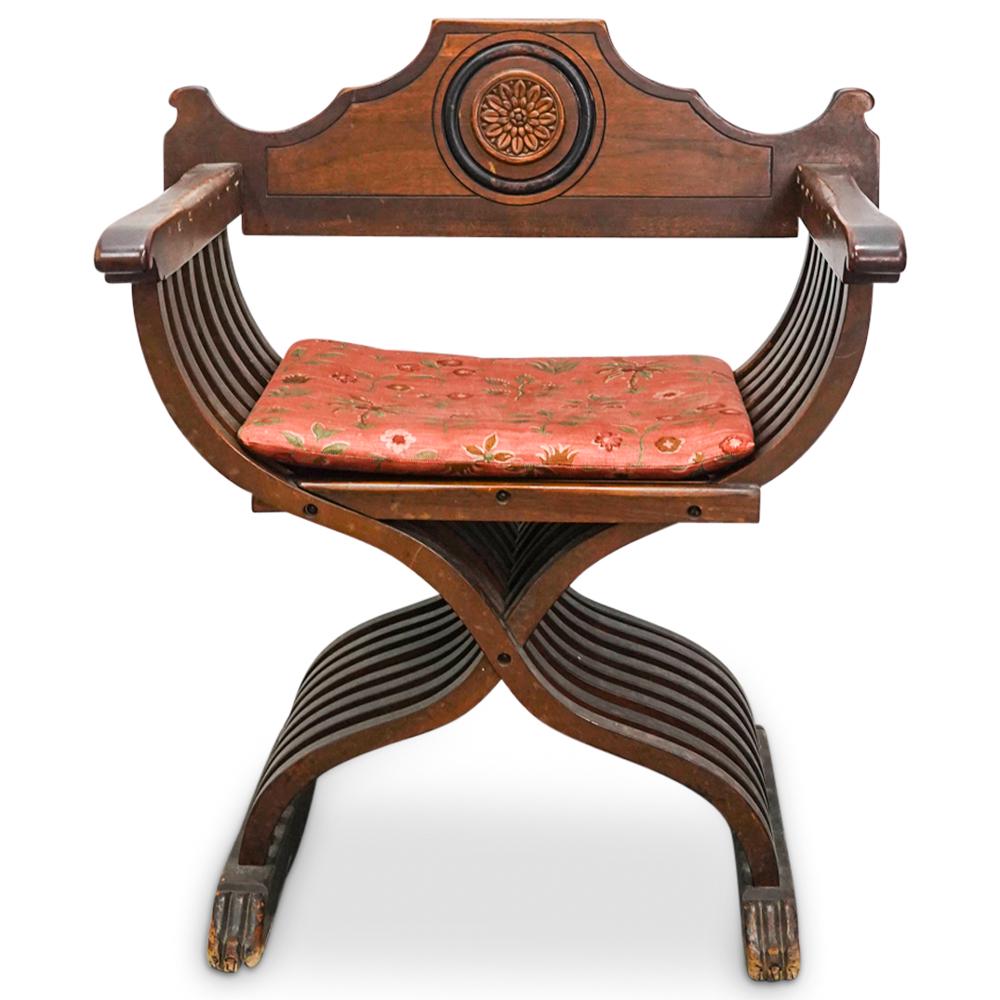 Antique Syrian Carved Wood Folding Armchair: DESCRIPTION: Antique carved wooden armchair featuring a removable back emblazoned with a floral medallion. Absent the back, chair is foldable and portable and is finished with beast form feet on eithe