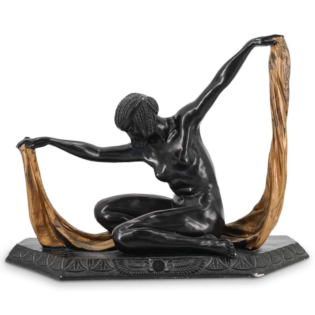 After Claire Jeanne Roberte Colinet Austin Production Sculpture: DESCRIPTION: Austin Production Inc composite Art Deco sculpture after Claire Jeanne Roberte Colinet depicting a nude woman with braids posing with a gilt sheet. Bears Colinet's signature on base adjac