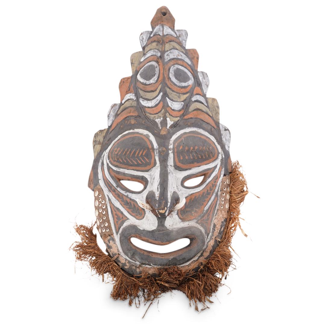 Oceania Wooden Tribal Mask: DESCRIPTION: Probably Papua New Guinean polychrome tribal mask featuring a fibrous beard, bone inserts in the nose, a high forehead, and cowry shell accenting on beneath the ears. CIRCA: 20th Century 