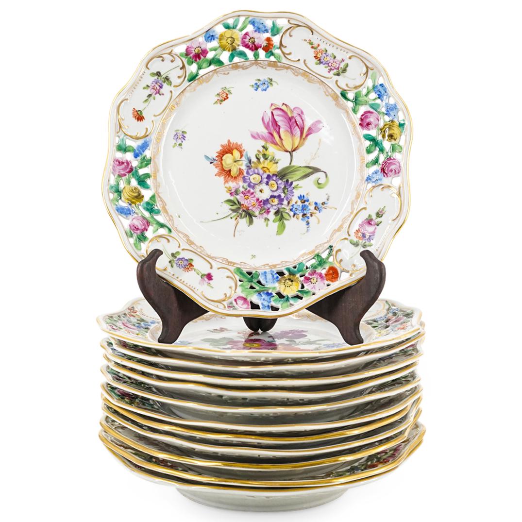 (12Pc) Antique Dresden Saxony porcelain Service Plate Set: DESCRIPTION: (12Pc) Dresden Saxony porcelain service plate set, features (12pc) plates with vibrant floral painted motifs, pierced, lattice rims, and scalloped edges. Each with underglaze Dresden mark