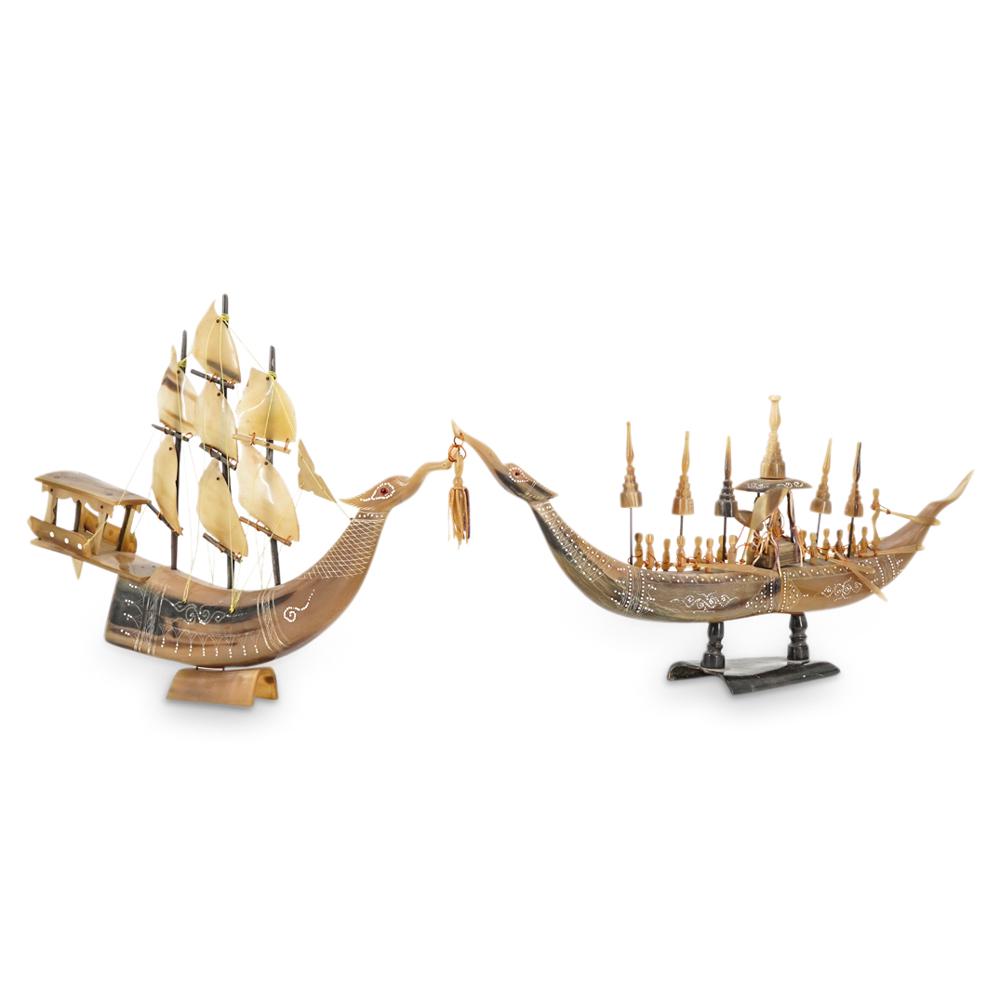 Pair Of Thai Carved Horn Boat Models: DESCRIPTION: Two models carved from bone, each depicting a southeast Asian boat: one with sails, one with row men. Each piece is fashioned with a prow adorned with the head of a mythical beast and fin