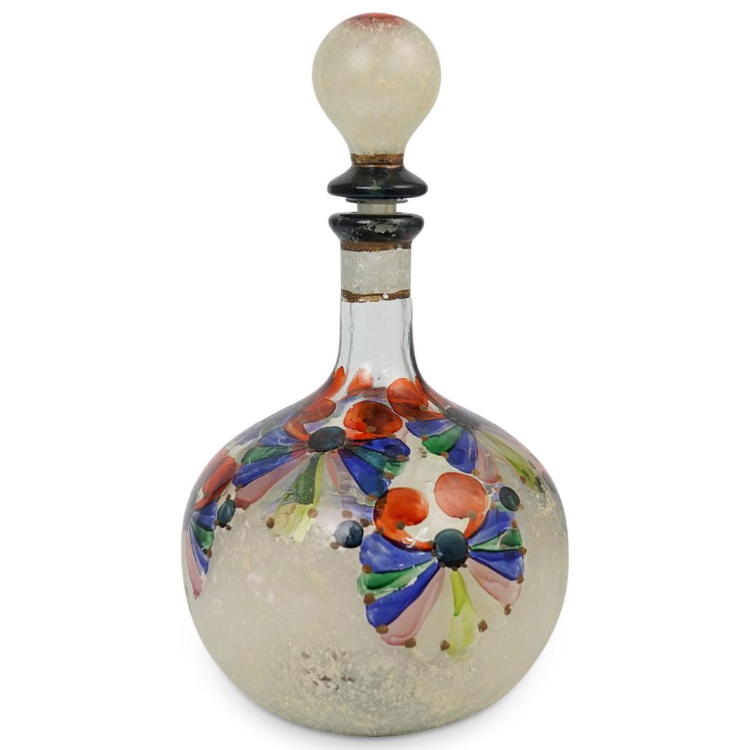 Vintage Murano Glass Decanter: DESCRIPTION: A Murano glass decanter with Roman glass style texture. Finished with multicolored shell patterns and a bulb shaped stopper. Handwritten script and signature underneath Illegible. CIRCA: 