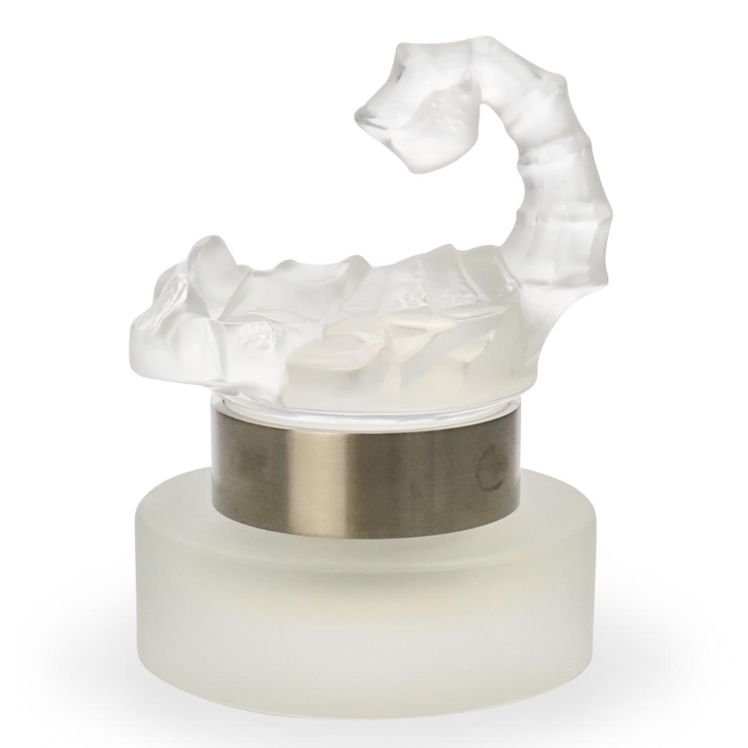 Lalique Factice "Skorpios" Crystal Bottle: DESCRIPTION: Lalique Factice "Skorpios" crystal fragrance bottle. Signed "Lalique France" underneath. CIRCA: 20th Cent. ORIGIN: France DIMENSIONS: H: 5" x D: 3.5" CONDITION: Great condition. See lot d