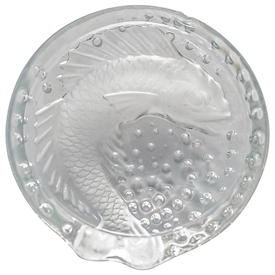 Lalique "Concarneau" Koi Fish Crystal Ashtray: DESCRIPTION: Lalique "Concarneau" crystal ashtray with embossed koi fish and embossed bubbles. Incised "Lalique France" on underside. CIRCA: 20th Century ORIGIN: France DIMENSIONS: H: 2" Diameter: 6" 