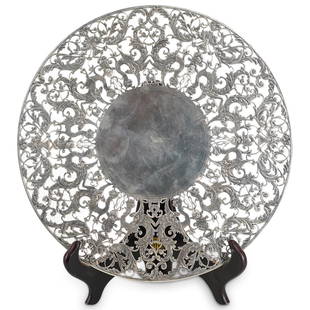 Roger Williams Rococo Sterling Silver Cake Stand: DESCRIPTION: Sterling silver cake plate by Roger Williams Silver Co. The piece features an intricate openwork pattern incorporating cherubs, dolphins, griffins and vines and stands on a short round co