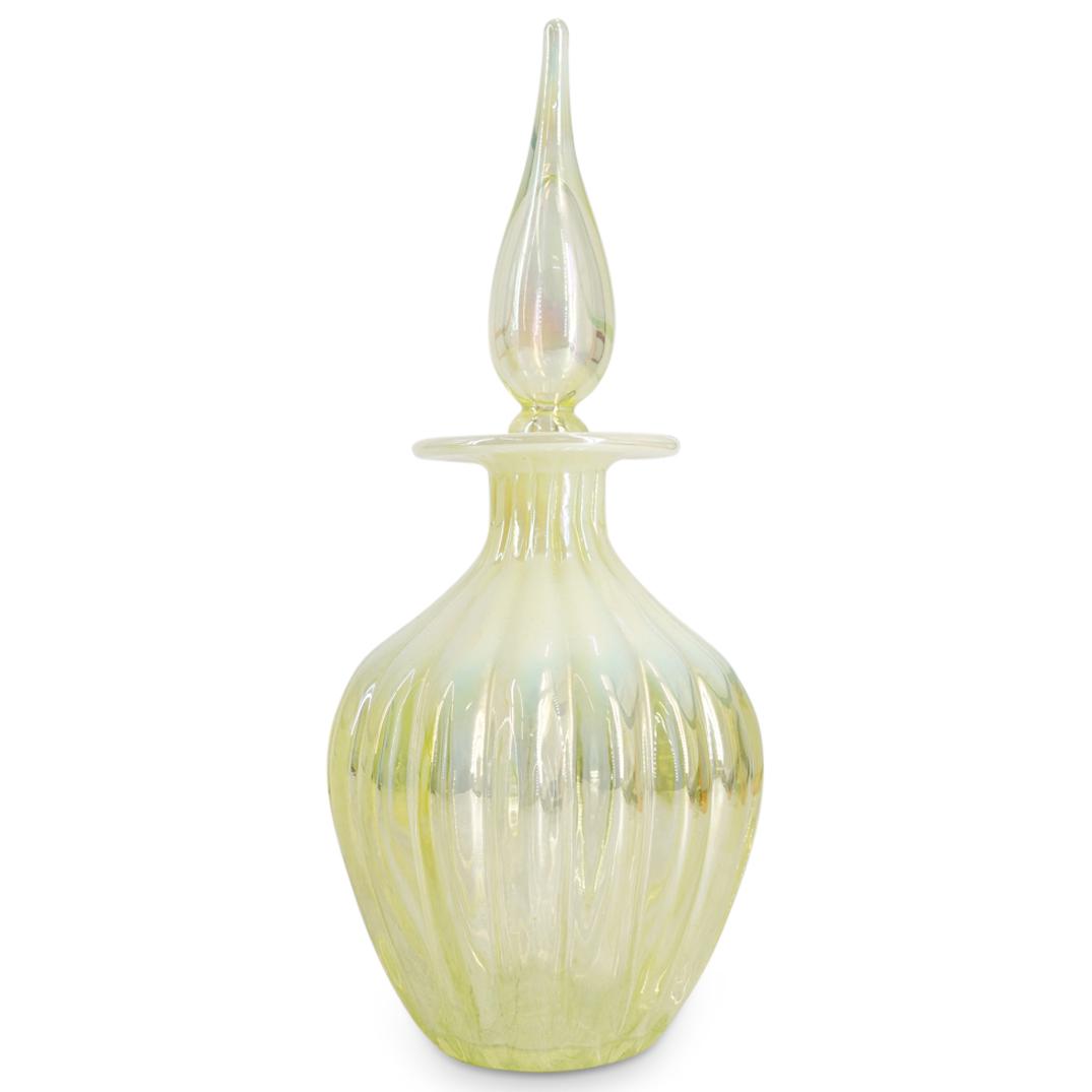 Gibson Vaseline Glass Ribbed Decanter: DESCRIPTION: A Gibson Vaseline glass decanter features a ribbed design with opalescent white accents along the shoulders a neck, completed with a pointed finial. CIRCA: 20th Century ORIGIN: USA DIMENS