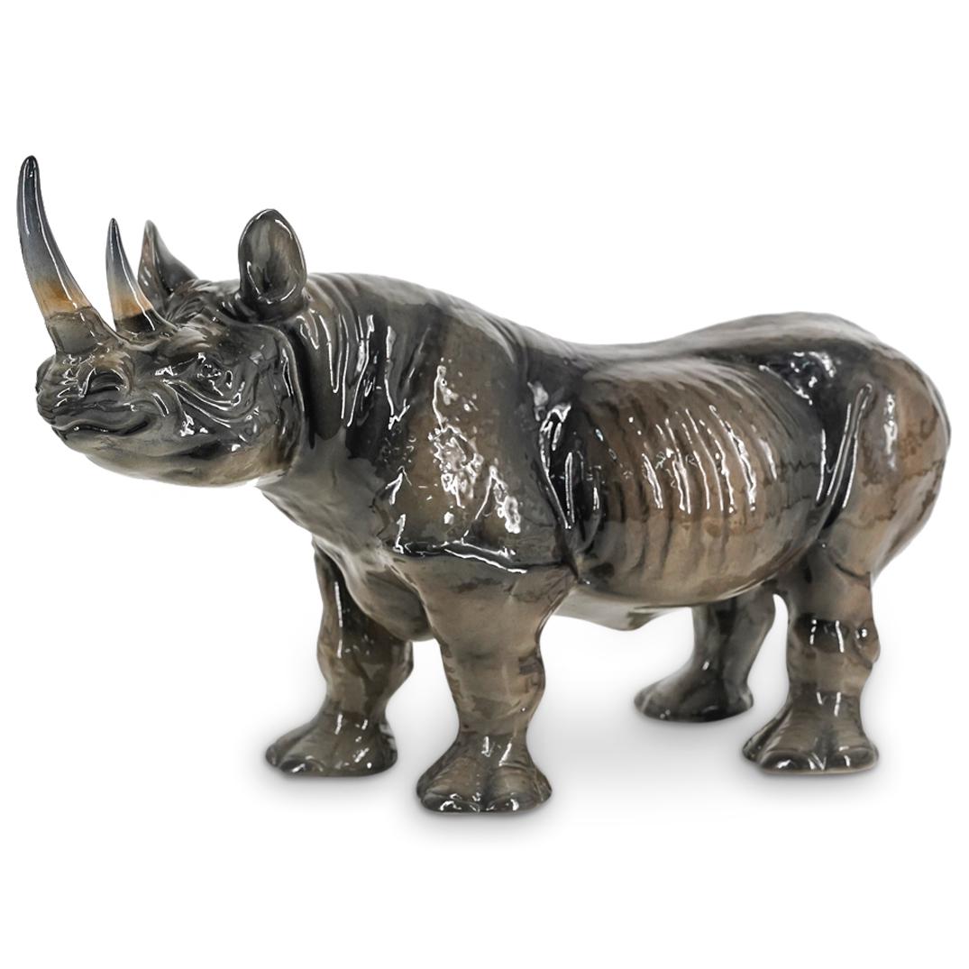 Italian Ronzan Ceramic Rhino Sculpture: DESCRIPTION: Ceramic rhinoceros sculpture by Ronzan featuring two horns and visible ribs. Marked with "Ronzan 1472|1 Made In Italy" on underside of foot. Sticker on side indicates retail by Florencia 