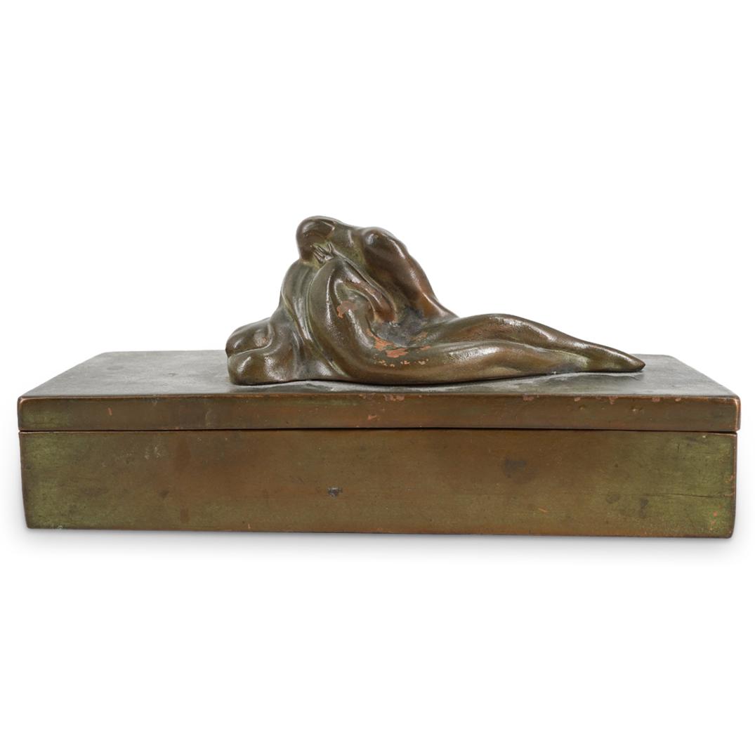 McClelland Barclay Bronze Figural Box: DESCRIPTION: McClelland Barclay bronze figural box with rectangular form and two mounted figures in interlocking erotic pose. Opens at hinge to reveal wood lined interior with four slots. CIRCA: 20th