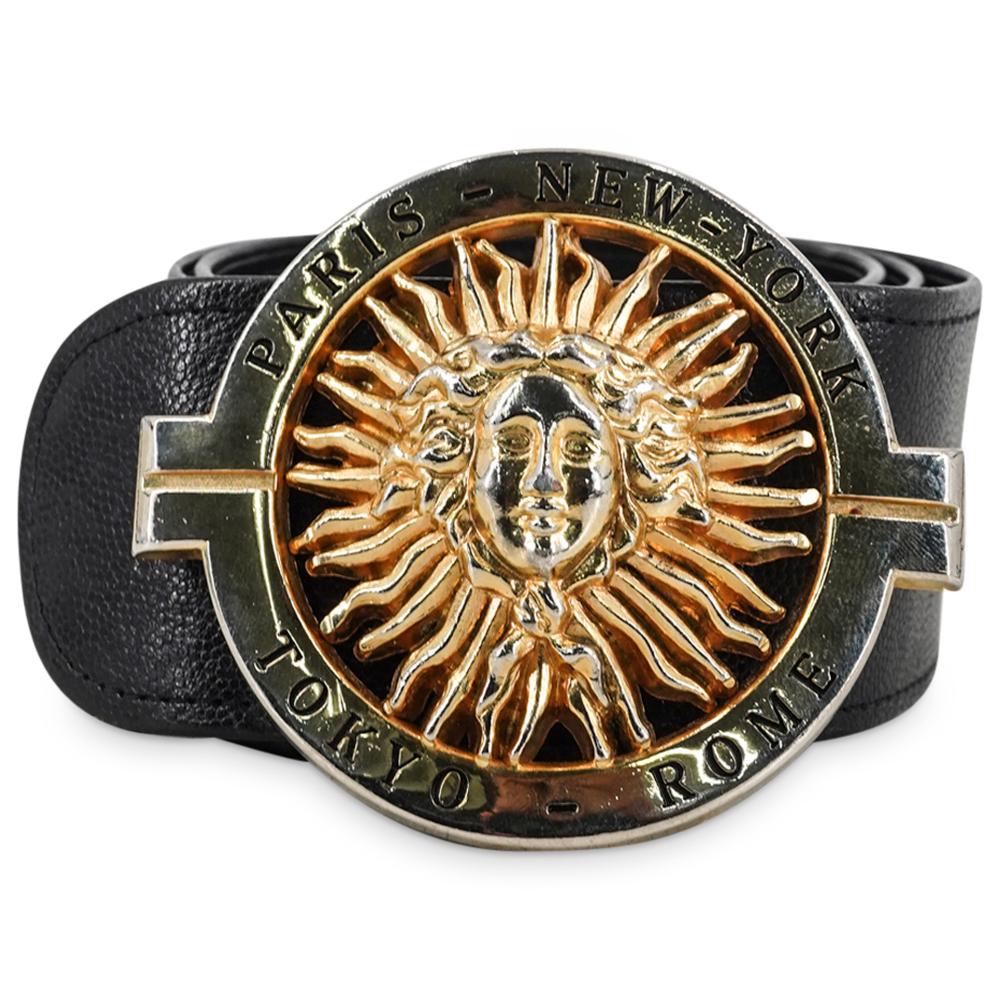 Vintage Lionhart Black Leather Waist Belt: DESCRIPTION: Vintage Lionhart black leather waist belt with gold tone metal frontal buckle designed with open an work motif depicting sun rays and a medusa head. With inscriptions Paris, New York, Tok