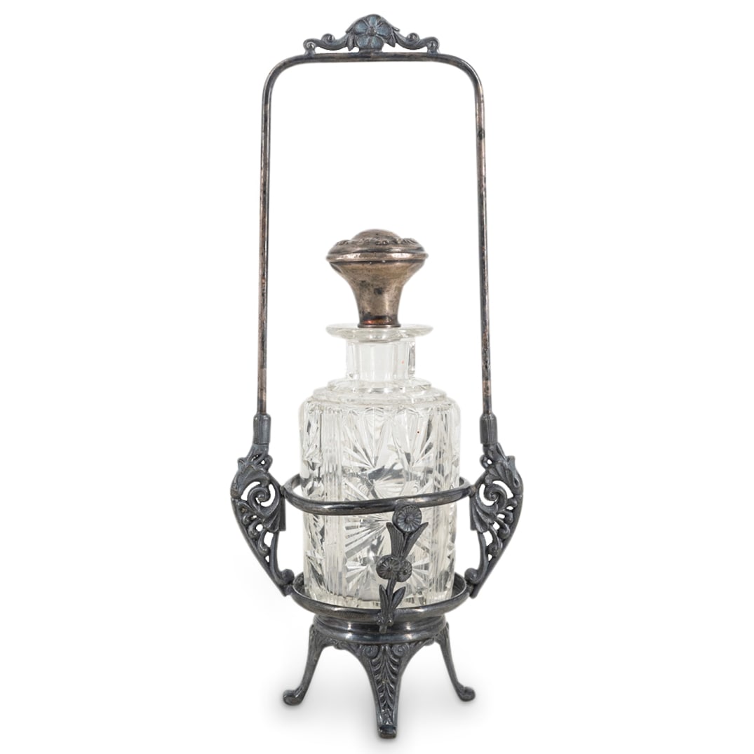 Antique Glass & Silver Perfume Bottle On Pewter Stand: DESCRIPTION: Antique cut glass perfume bottle with sterling silver stopper, on a pewter ornate footed stand. The stopper is marked "Sterling". The stand is marked "Rogers Smith & Co. Meriden". Monogra