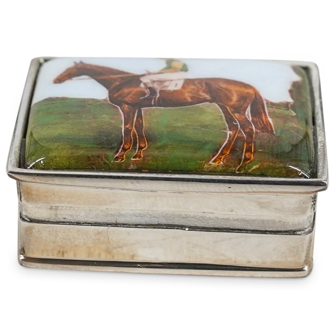 Sterling Silver Equestrian Enameled Sterling Pill Box: DESCRIPTION: A sterling silver pill box of rectangular form, embellished with an enamel decorated motif on the lid depicting a jockey on horseback. Stamped: "Sterling." Total Weight: 26 grs. CIRCA: 20