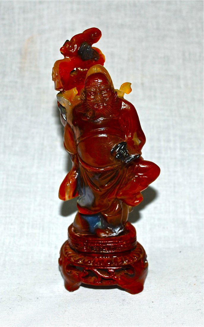 Antique Chinese very rare agate figurine: DESCRIPTION: Antique Chinese agate figurine of a king with one leg up holding a fan. Signed on the stone with a wood base CIRCA: early 1900s MADE IN: china DIMENSIONS: H:6" L:2.25"