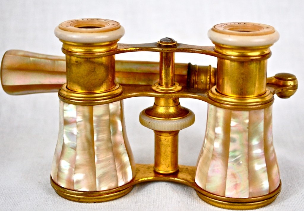 Antique Mother-of-Pearl Opera Glasses with Handle: DESCRIPTION:Antique French Mother-of-Pearl Opera Glasses with Handle. Marked Lemaire Paris. CIRCA: 1880s MADE IN: France DIMENSIONS :5"x2 1/2"