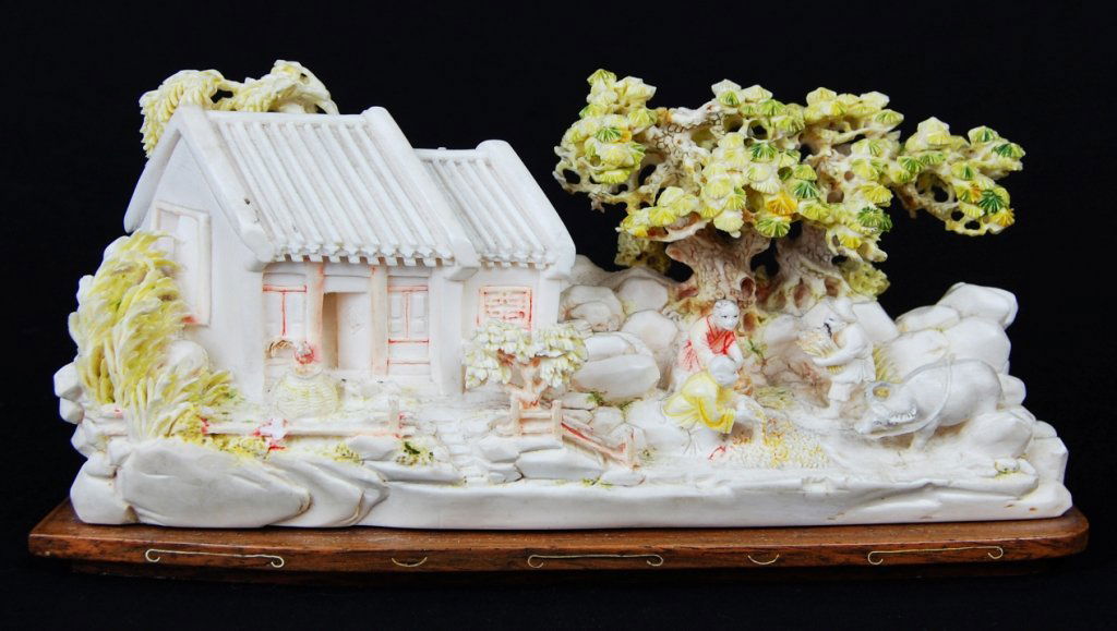 Chinese antique ivory village with figurines. Mark: DESCRIPTION: Ivory hand carved village with figurines and painted trees on a wood base. Marked CIRCA: 1880-1920s MADE IN: China DIMENSIONS: H:5" L:9.5"