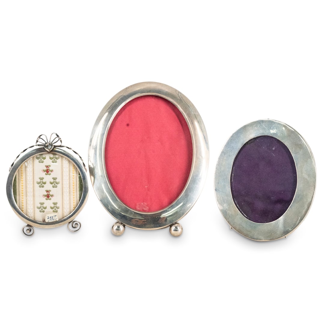 (3 Pc) Sterling Silver Photo Frames Grouping Set: DESCRIPTION: (3 Pc) Antique sterling silver photo desk frames grouping set, in oval and circular shapes. Marked with sterling silver hallmarks. CIRCA: Early 20th Century DIMENSIONS: H: 4" ; 5"; 6 1/2"