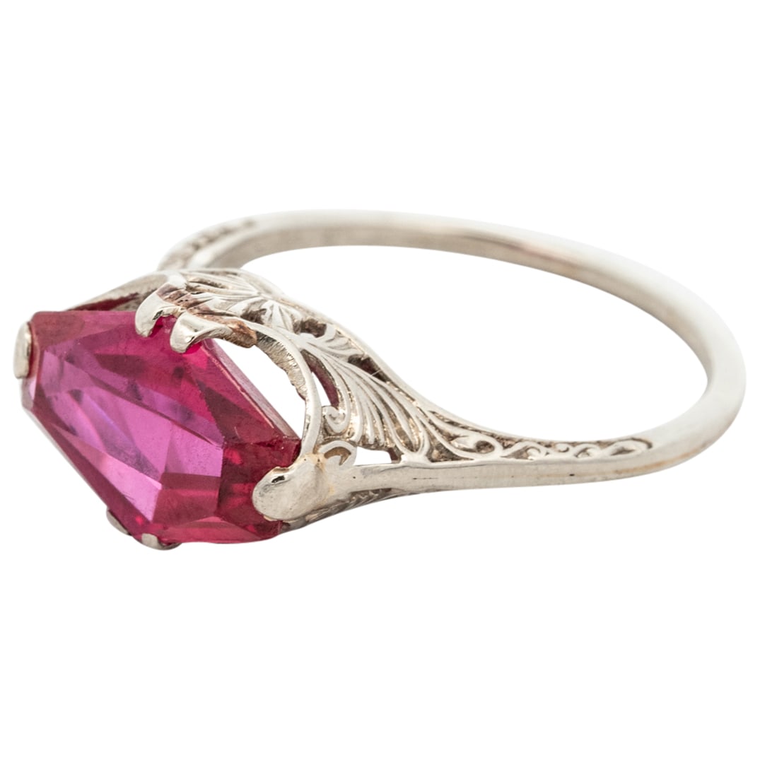 14k Gold and Garnet Ring: DESCRIPTION: A 14k white gold ring featuring ornate open work along the shoulder and setting, inset with an approx. 3ct garnet, stamped along the inner band "14k". Total Weight: 2.7 grams (1.7 dwt) CI