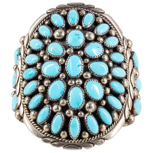 Navajo Moore Sterling Silver and Turquoise Cuff: DESCRIPTION: A Sterling Silver Cuff bracelet decorated with a series of Turquoise inserts, completed with open work terminals, stamped along the back "Moore" "Sterling". Total Weight: 104 Grams CIRCA: