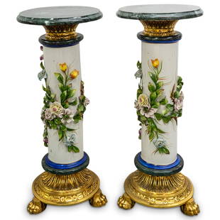 Pair Of Capodimonte Pedestals: DESCRIPTION: Two matching antique Capodimonte pedestals, each featuring a porcelain column adorned with flowers and winding foliage in high relief and supported by a marble and gilt metal tripod base