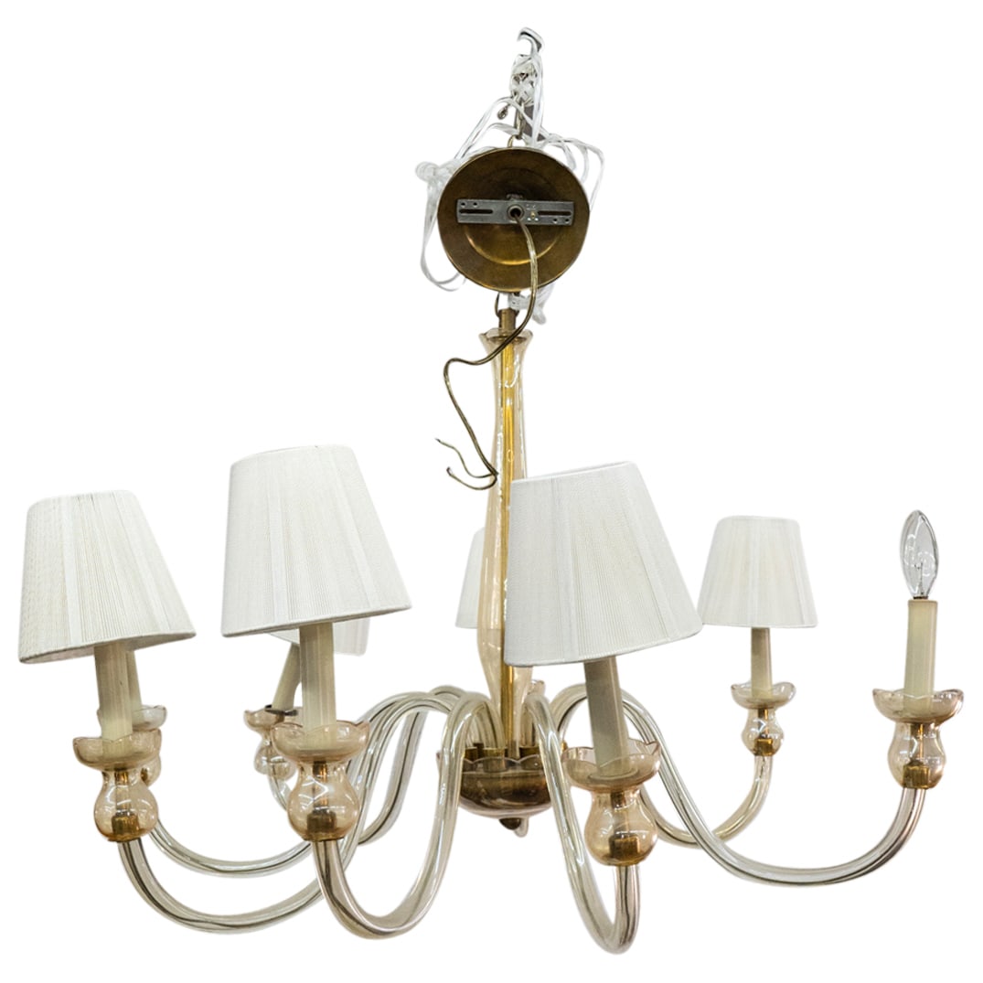 In Style Of Donghia Stellare 8 Arm Chandelier: DESCRIPTION: Murano glass chandelier crafted in the style of Donghia Stellare featuring eight glass arms-each ending in a shaded socket-extending from a central glass covered bronze cup hanging from a